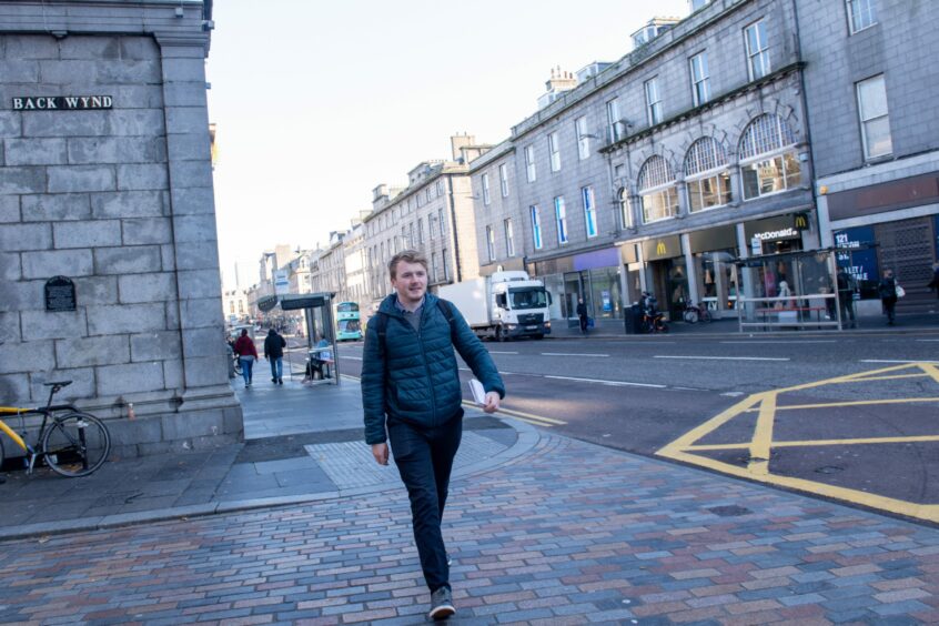 Craig walking forwards, with Union Street's McDonald's in the background. 