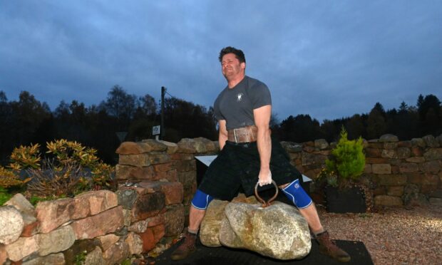 Captain Guy Holder Williams tried to lift the famous Dinnie Stones for charity. Picture by Paul Glendell / DC Thomson.