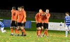 Aidan Wilson, second from right in tangerine, is congratulated by Rothes team-mate Fraser Robertson after scoring their first goal against Banks o' Dee.