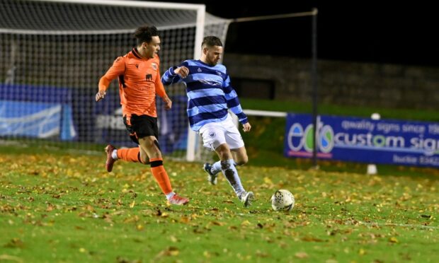 Matheus Machado of Rothes, left, puts Banks o' Dee's Marc Young under pressure