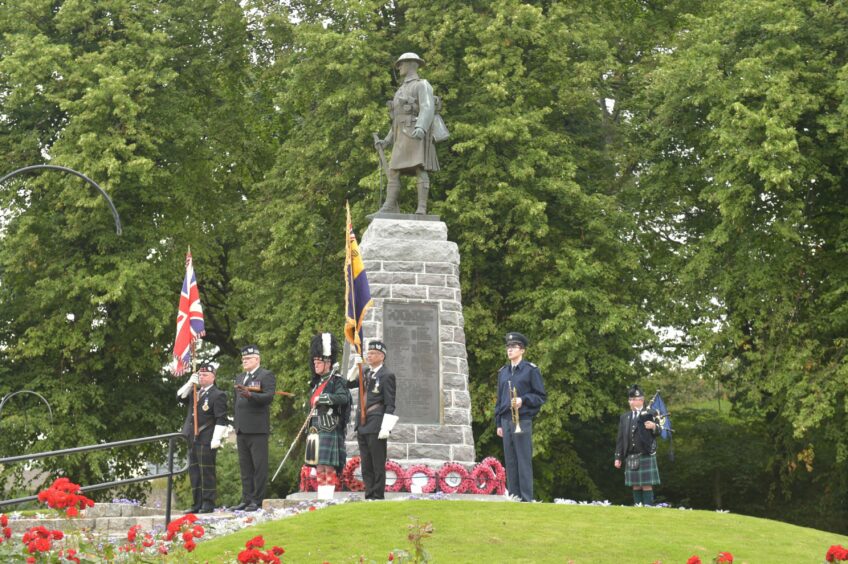 Forres War memorial during Remembrance Day parade.