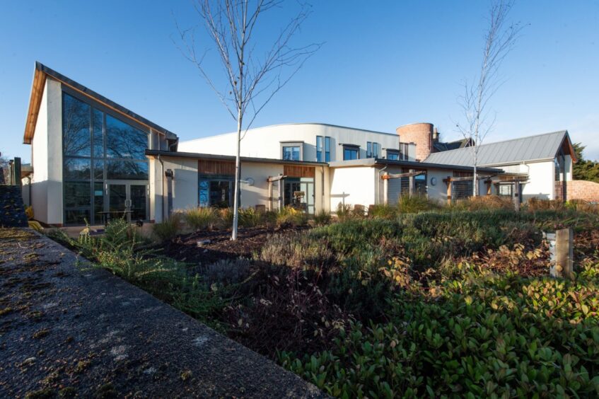 Exterior image of the Highland Hospice building glistening in the sun.