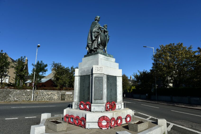 Fraserburgh War Memorial with wreaths of poppies at its foot