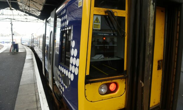 Close-up image of ScotRail train in Inverness station looking down platform.