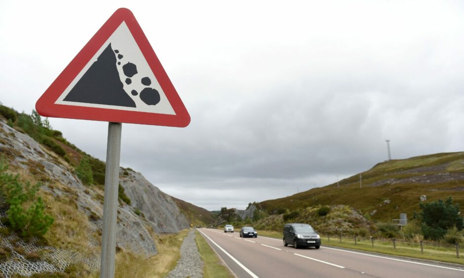 A falling rock warning sign on a section of the A9 at Slochd, north of Carrbridge.