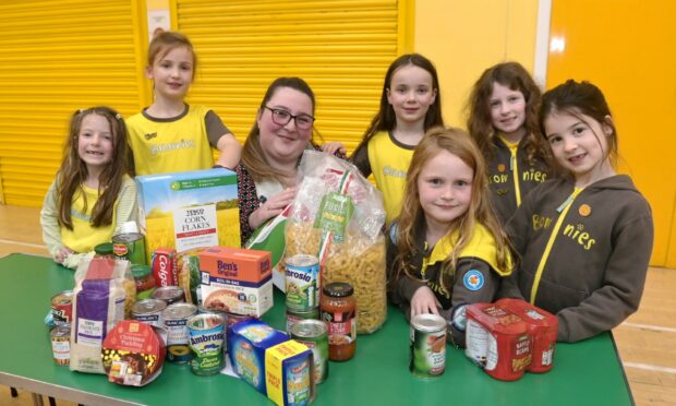 Cradlehall Brownies and Rainbows supported the appeal this year. Brownies from L-R: Elle McGuire, Islay Liptrot, Daphne Gray, Daisy Baxter, Ivy McGuire, Iona Smith with Press and Journal reporter Michelle Henderson. Image: Sandy McCook/ DC Thomson