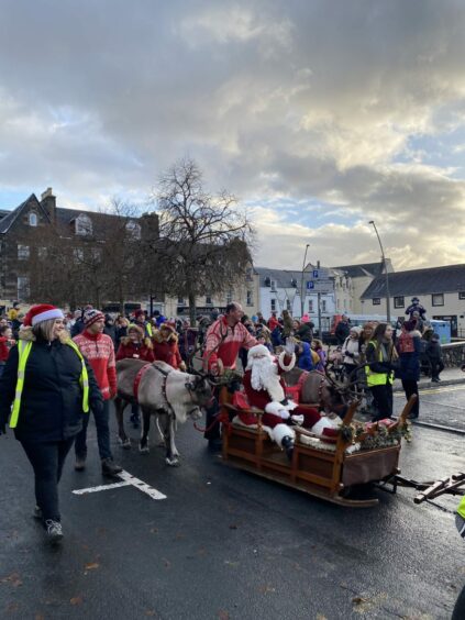 Santa Claus on a sleigh with reindeer in Portree, Isle of Skye.