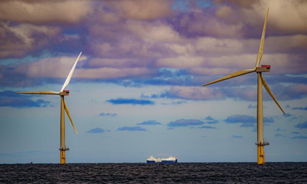 A photo of a ship between two wind turbines (energy industry Aberdeen)