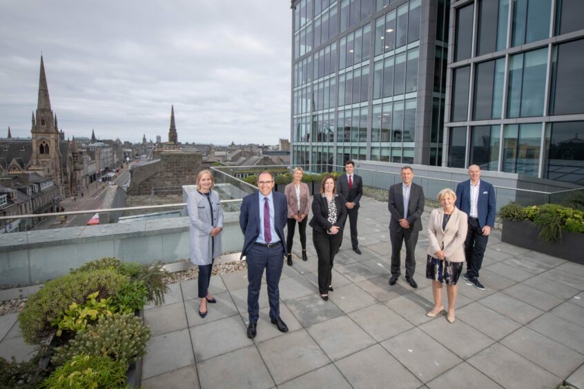 Standing on a pavilion on the new Shell Union Street office, from left, OGUK chief executive Deirdre Michie, Shell UK upstream senior-vice-president Simon Roddy, corporate relations analyst Florence Stanton, HR manager Joanne Bremner, Aberdeen City Council finance convener (at the time) Ryan Houghton, Aberdeen and Grampian Chamber of Commerce's Russell Borthwick, then-council leader Jenny Laing and Mr Padraig McCloskey.