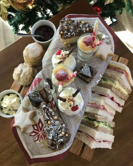 A Christmas themed afternoon tea including star-shaped shortbread, scones and sandwiches