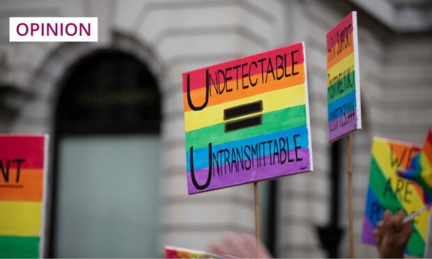An HIV-related placard, held aloft during Pride in London (Image: Ink Drop/Shutterstock)