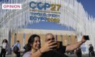 Two people take selfies at the COP27 UN climate summit in Egypt (Image: Peter Dejong/AP/Shutterstock)