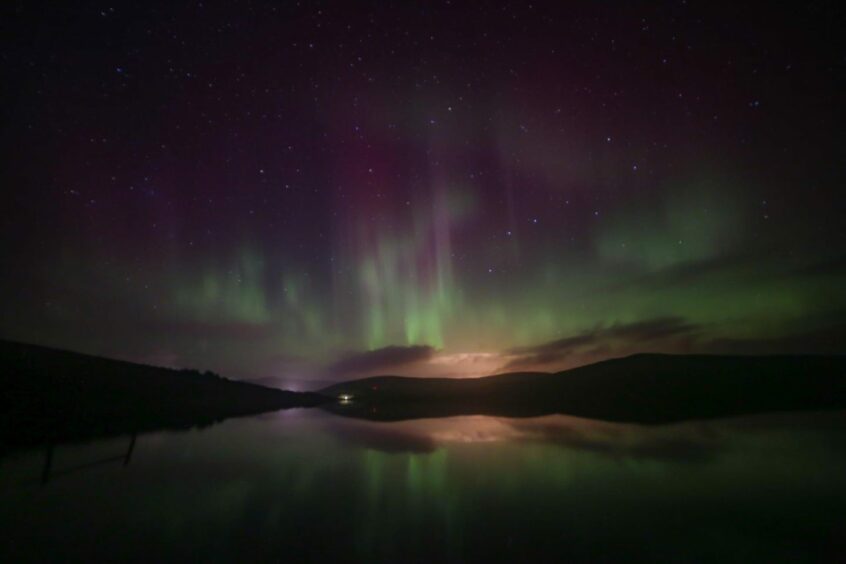 Northern Lights across lake in Shetland