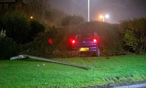 The car came to a stop in the bushes in the middle of the roundabout. Image: Wullie Marr/DC Thomson