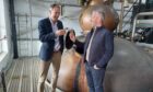 Highland Hospice’s chief executive Kenny Steele and Tomatin Distillery director Stephen Bremner toasting to successful collaboration. Image: Tomatin Distillery.