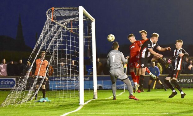Falkirk's Gary Oliver powers a header past Wick keeper Graeme Williamson to put Falkirk 3-0 ahead. Image: Mel Roger.