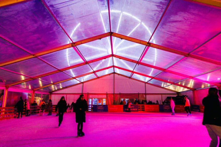 People skating on the ice rink at Dundee Winterfest.