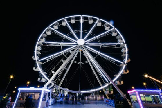 The ferris wheel is lit up at night for Dundee's Winterfest