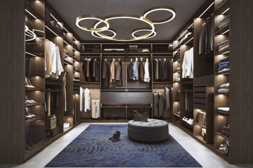 A bespoke walk-in wardrobe design from Komandor, featuring atmospheric lighting.