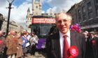 Donald Dewar, Aberdeen, in front of a group of people crowded around a bus called "Holyrood Express"
