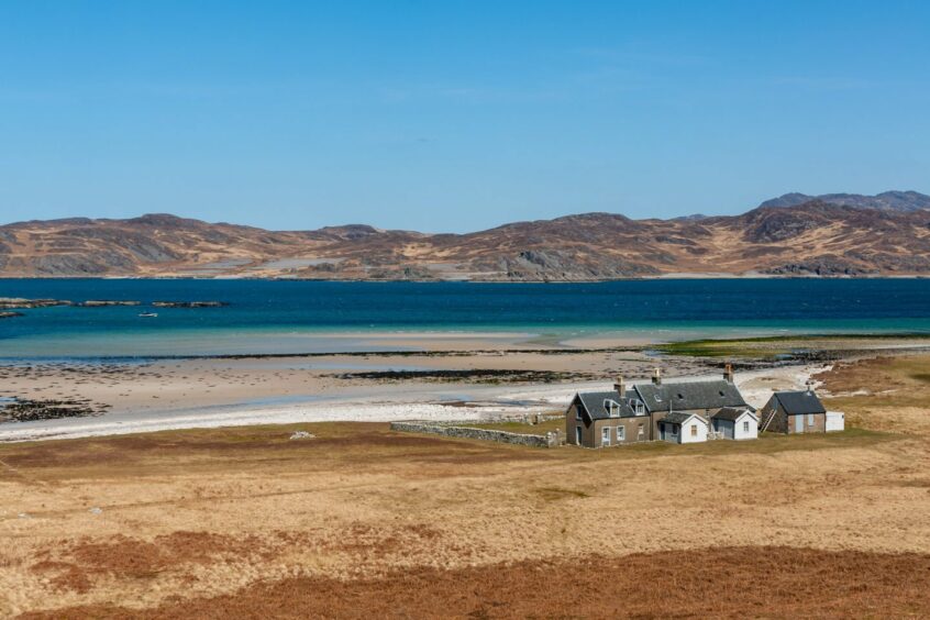 Isle of Jura with a house next to a beach
