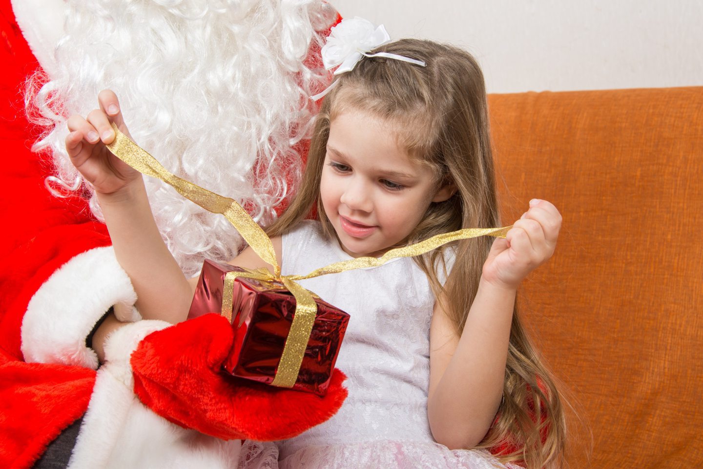 Child opening present from Santa