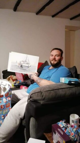 David Lapage with a drawing of a fishing boat