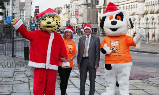 Dozens of Santas will run down Union Street this month for Charlie House. From left to right, Spotless the Leopard, Susan Crighton, director of fundraising at Charlie House, Lord Provost David Cameron and Charlie Dog. Supplied by Charlie House