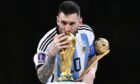 Lionel Messi with the World Cup. Photo by Fabio Ferrari/LaPresse/Shutterstock.