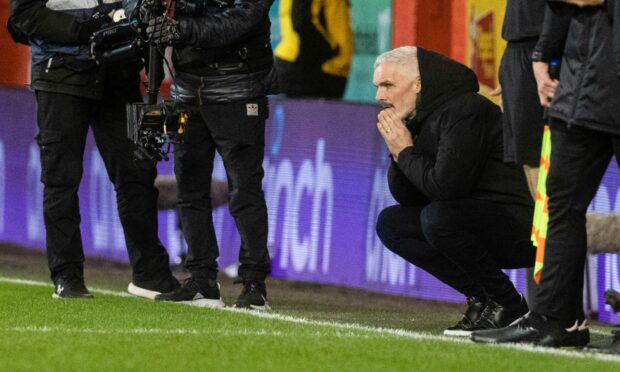 Aberdeen manager Jim Goodwin looks dejected after his side lose 3-2 to Rangers. Image: SNS.
