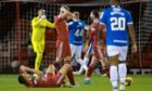 Aberdeen's Ross McCrorie and Ylber Ramadani look dejected at full-time following the Premiership loss to Rangers at Pittodrie. Image: SNS