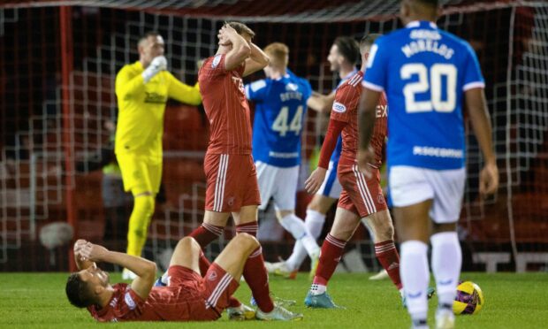 Aberdeen's Ross McCrorie and Ylber Ramadani look dejected at full time after losing 3-2 to Rangers. Image: SNS