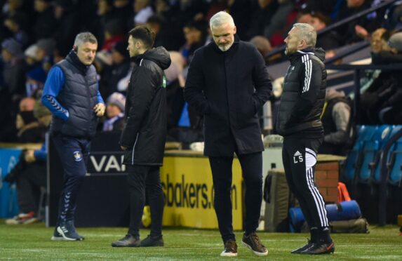 Dons boss Jim Goodwin was left dejected following his side's 2-1 loss at Kilmarnock. Image: SNS