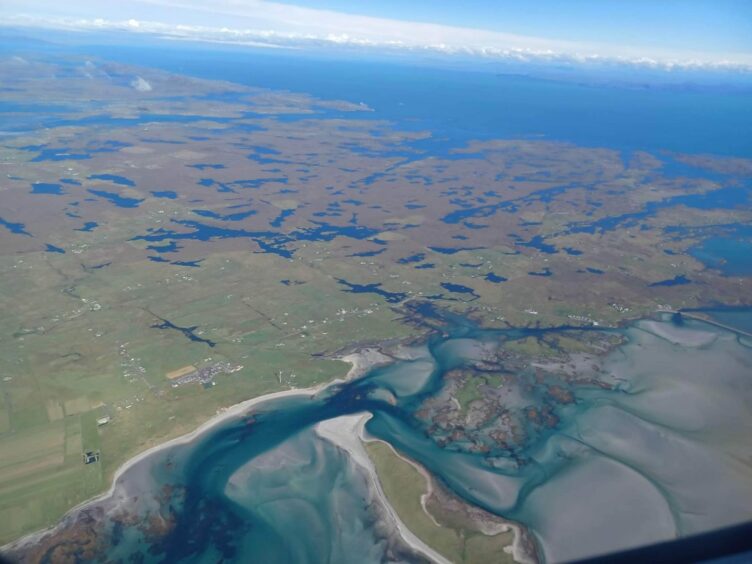 A view of from the plane window as it takes off from Benbecula