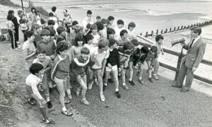 Oldmachar Academy Aberdeen students line up along the beach promenade for a sponsored run along the beach