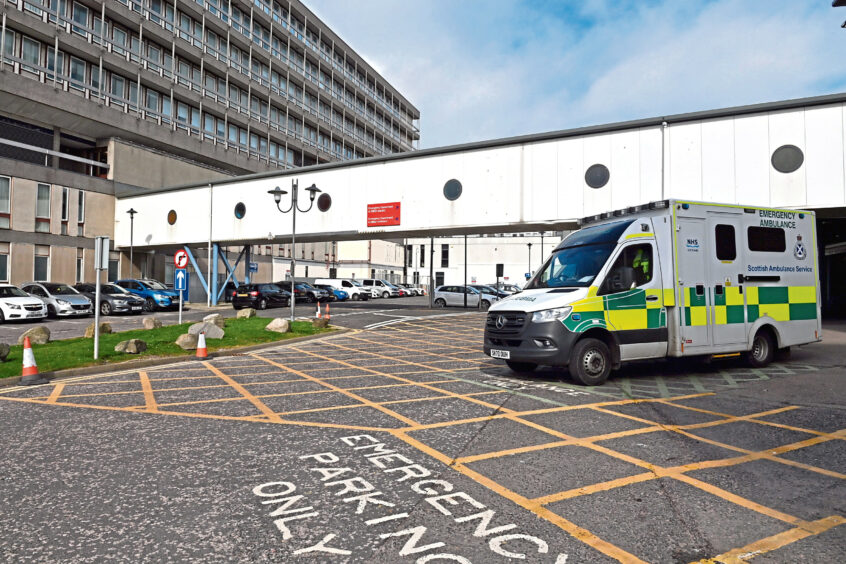 An ambulance parked outside Aberdeen Royal Infirmary during a time of long NHS waiting times