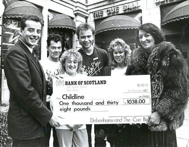 1987 - General manager of the Cue Ball Mark Elliot, left, hands over a cheque to Trish Lively, right, chairwoman of Childline North East.