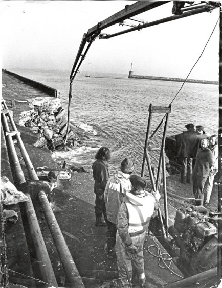 1979 - Repairs to Aberdeen's North Pier get under way yesterday after part of it collapsed.