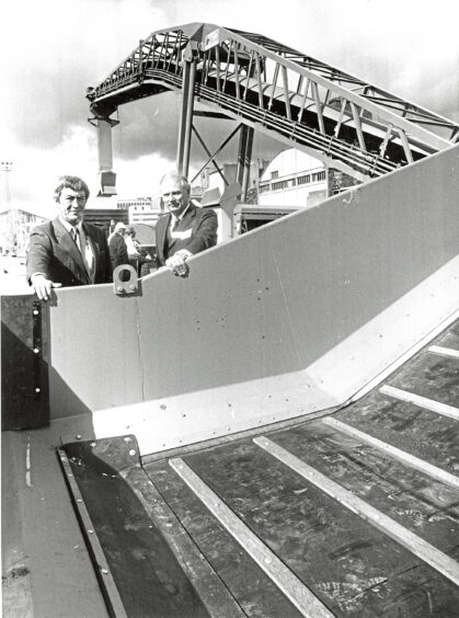 1987 - Harbour board general manager John Turner and Cargill UK executive Niall Foley, take a look at a new conveyor.