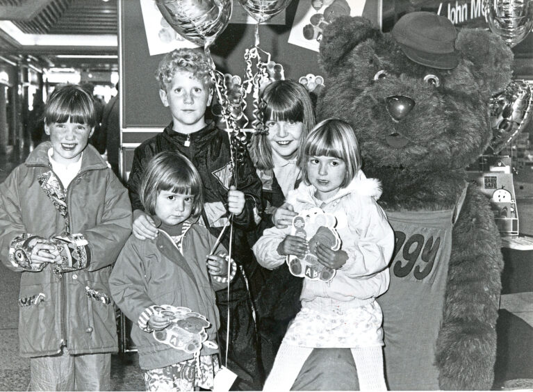 1991 - Huggy Bear meets Laura King, Susan Currie, Stewart McIntosh, Tracey McIntosh and Gillian Currie during a toy safety roadshow at St Nicholas Centre in Aberdeen. 