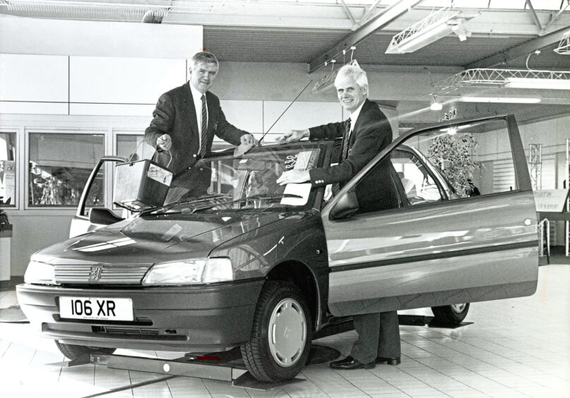 1991 - Brothers John and George Morrison celebrate 25 years of their car dealership business. 