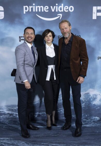 Martin Compston, Emily Hampshire and Iain Glen on the red carpet, which looks like the sea, at The Rig premiere. 