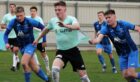 Aidan Combe, centre, in action for Formartine United is hoping to get the better of his former club Fraserburgh. Picture courtesy of Ian Rennie/Formartine United