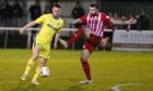 Josh Peters, left of Buckie Thistle battles with Formartine United's Kieran Adams