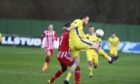 Buckie Thistle's Hamish Munro, right, clears under pressure from Julian Wade of Formartine United