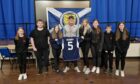 Colin Hendry pictured with Highlife Highland young leaders in Thurso holding Colin Hendry's famous number five shirt. They are from left: Ava Steven, Liam Mackinnon, Nyah McAdie, Colin Hendry, Keira Gunn, Ami Alexander, Connor Gunn and Cadie Cannop.