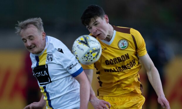 Inverurie Locos' Jamie Michie, left, and Ryan MacLeman, right, of Forres Mechanics battle for the ball