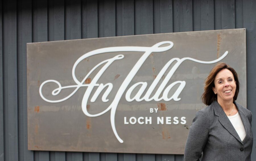 Freda Newton in front of Loch Ness by Jacobite sign