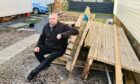 Robert Haytack sits on one of the many empty plots at Lossiemouth Bay Caravan Park. Image: Jason Hedges / DC Thomson