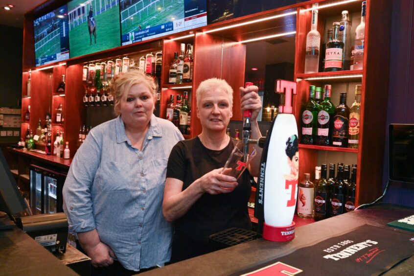 The Imperial Inverness manager and assistant manager behind the bar, the assistant manager is pouring a pint of Tennants
